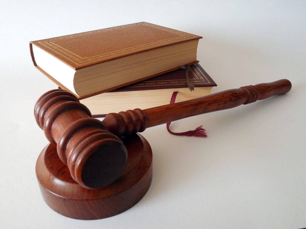 A wooden gavel placed beside law books, symbolizing judicial authority and legal decision-making in India, relevant to the Collegium system and NJAC debate on judicial appointments