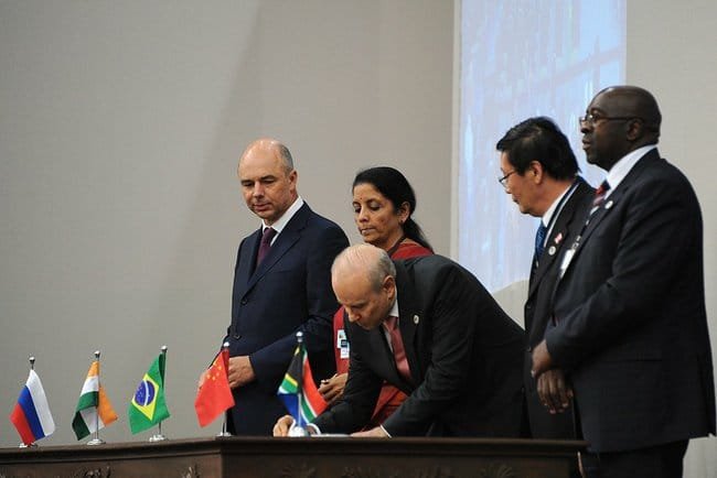 BRICS finance ministers and representatives from Russia, India, Brazil, China, and South Africa signing official documents during the 6th BRICS Summit, symbolizing global economic cooperation and diplomatic partnership.