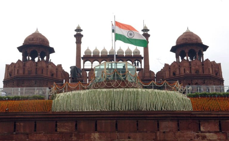 The Indian national flag flying atop the Red Fort in Delhi, symbolizing India’s Independence Day celebrations.