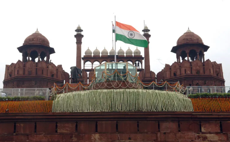 The Indian national flag flying atop the Red Fort in Delhi, symbolizing India’s Independence Day celebrations.